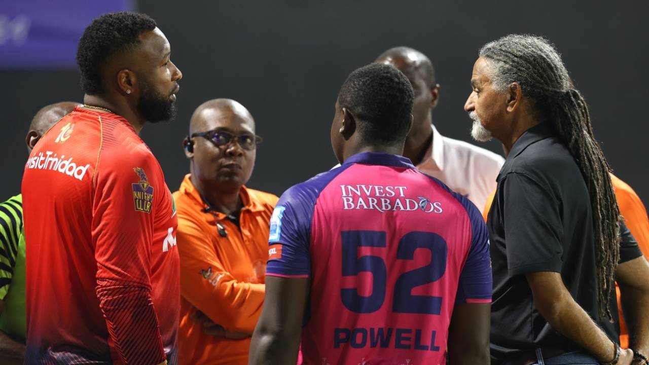 Kieron Pollard and Rovman Powell have a chat with match officials after a floodlight failure stopped play, Trinbago Knight Riders vs Barbados Royals, Eliminator, CPL 2024, October 1, 2024
