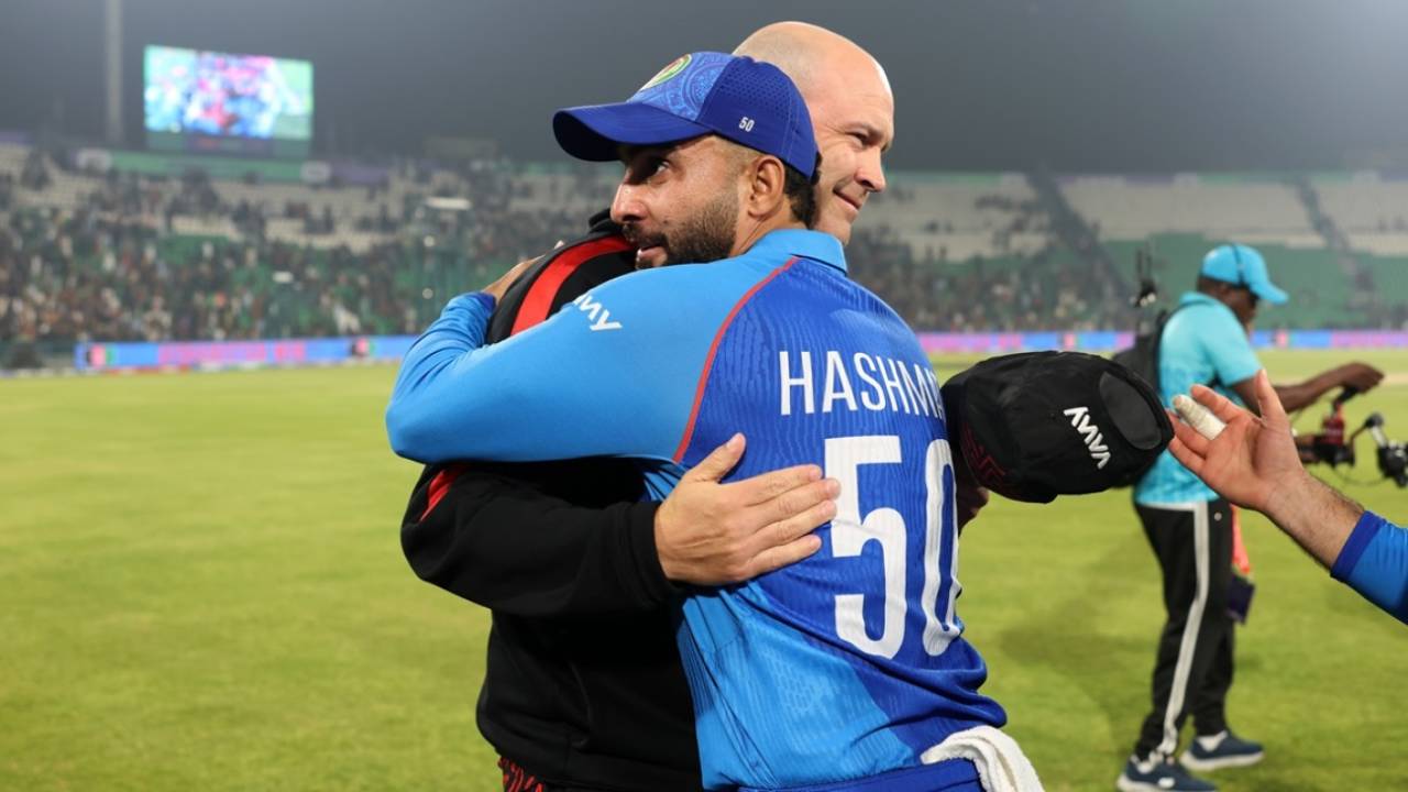 Jonathan Trott and Hashmatullah Shahidi embrace after Afghanistan's win, England vs Afghanistan, Lahore, ICC Champions Trophy, February 26, 2025