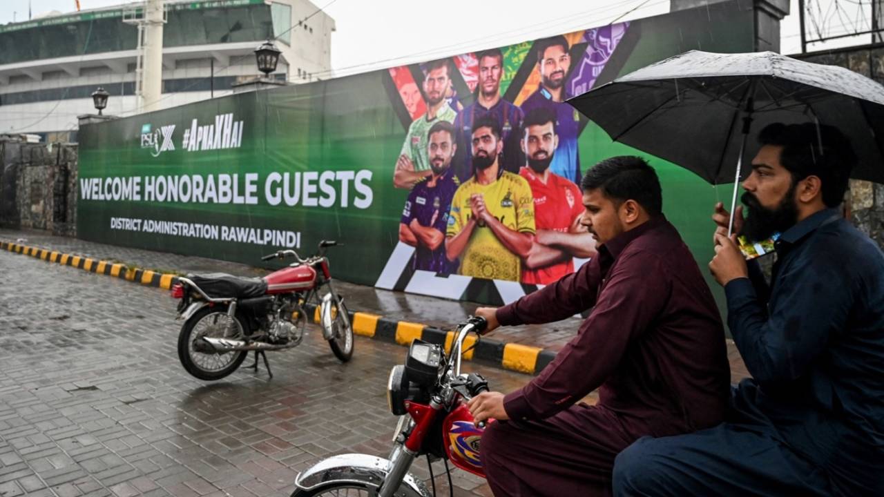 Men ride on a motorbike in front of the Rawalpindi cricket stadium after an alleged drone was shot down, Rawalpindi, May 8, 2025