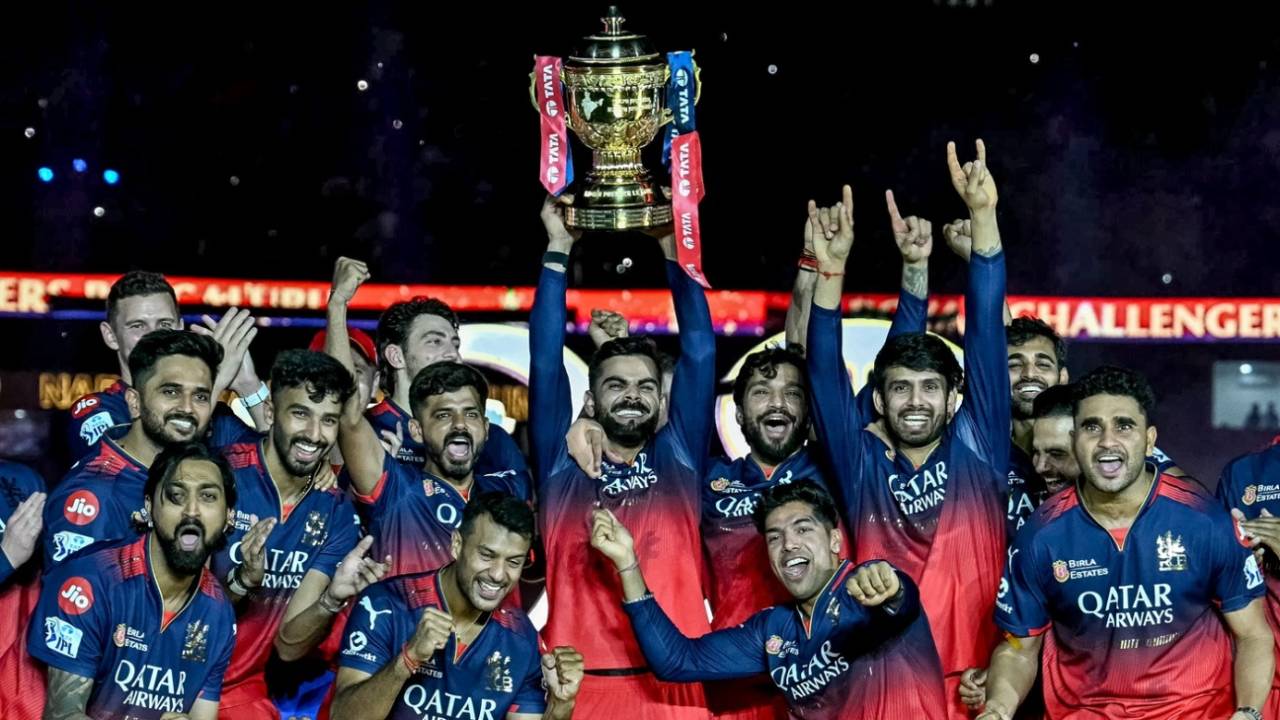 Virat Kohli, with the trophy in hand, celebrates RCB's IPL win with rest of his team-mates, Punjab Kings vs Royal Challengers Bengaluru, IPL 2025 final, Ahmedabad, June 3, 2025