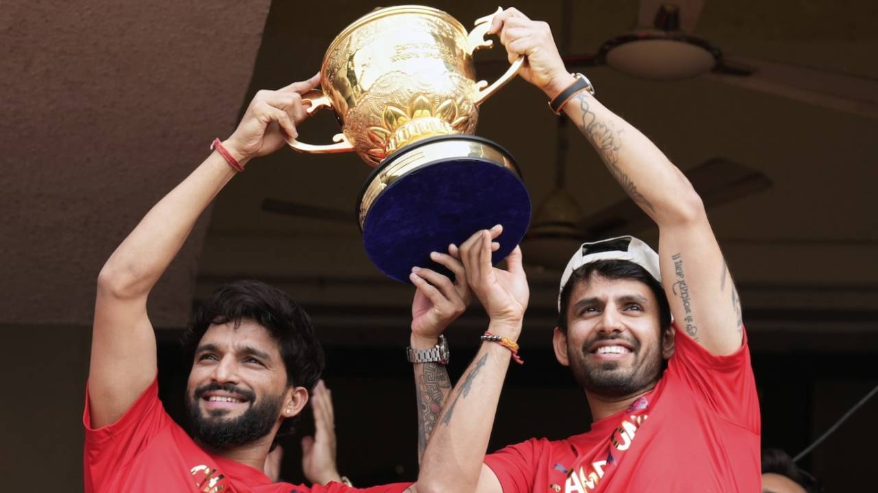 Rajat Patidar and Jitesh Sharma hold the IPL trophy up for the fans, Bengaluru, June 4, 2025