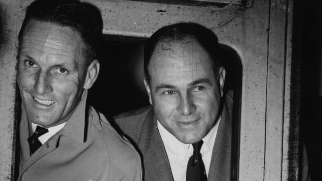 Dudley Nourse and Eric Rowan lean out of their train carriage window holding a springbok toy as they begin the journey home from Waterloo Station, London, September 20, 1951.