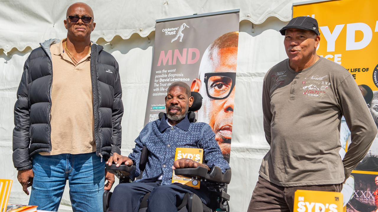 Courtney Walsh and David Lawrence (centre) pose with Lawrence's book <i>In Syd's Voice</i> at a charity event in Downend Cricket Club in Bristol, June 6, 2025