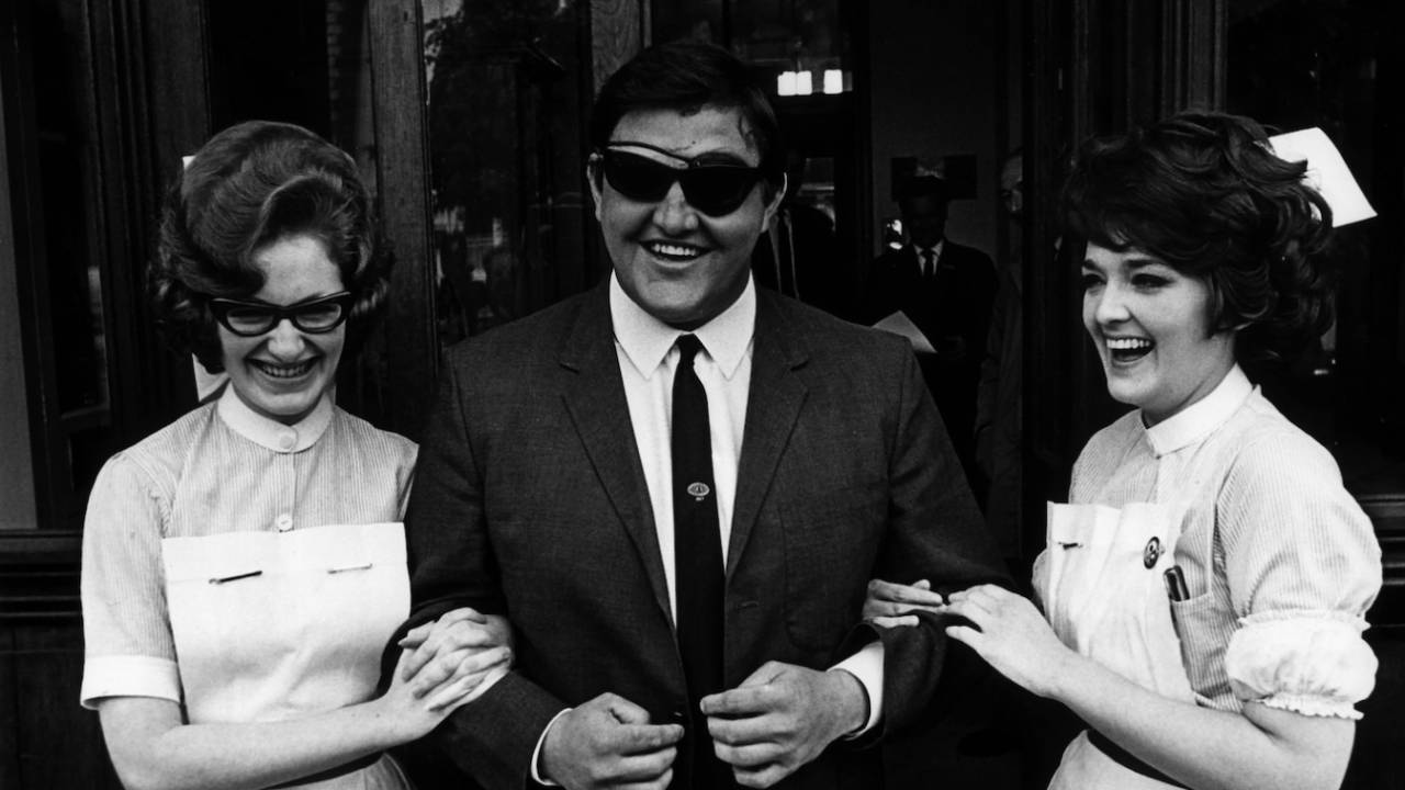 Colin Milburn leaves the hospital laughing after getting surgery on his left eye, does commentary for the BBC, Old Trafford, June 05, 1969