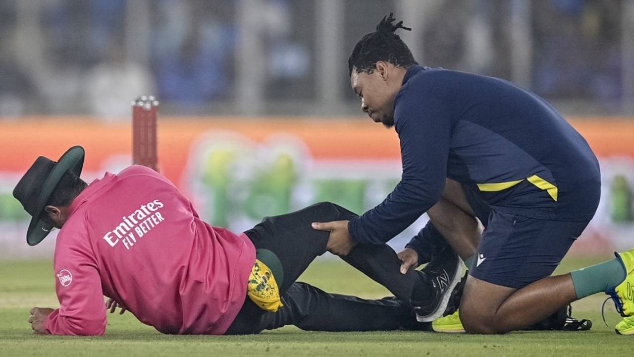 Umpire Rohan Pandit gets some attention from South Africa's physio after taking a blow to his shin, India vs South Africa, 5th T20I, Ahmedabad, December 19, 2025
