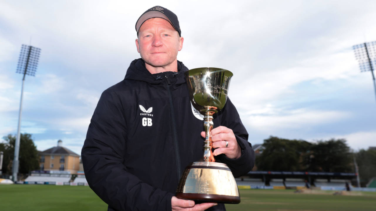 Gareth Batty, Surrey's head coach, poses with the County Championship trophy, September 29, 2024