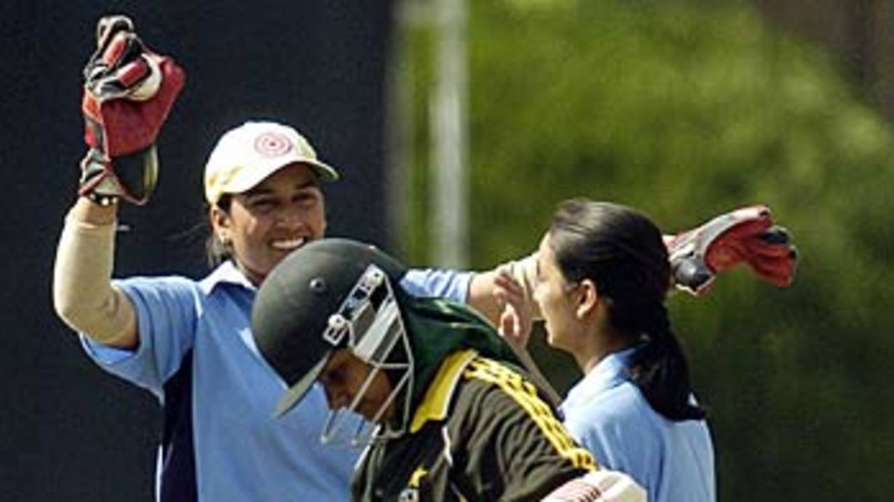 Delhi Blues Bod's wicketkeeper Gurdeep Kaur celebrates with her team-mates  after the dismissal of PCB Greens' Sana Javed 