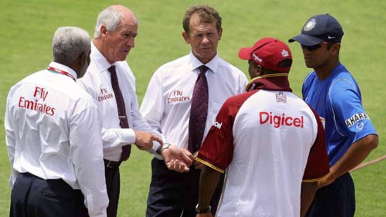 The umpires have a chat with the two captains as wet weather delays the start of play, India in West Indies, 3rd Test, St. Kitts, 1st day, June 22, 2006