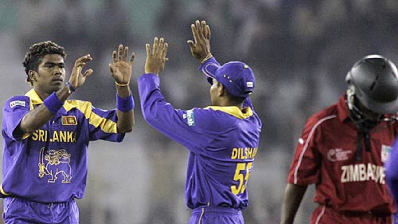 Lasith Malinga and Tillakaratne Dilshan celebrate the wicket of Tafadzwa Maufambisi