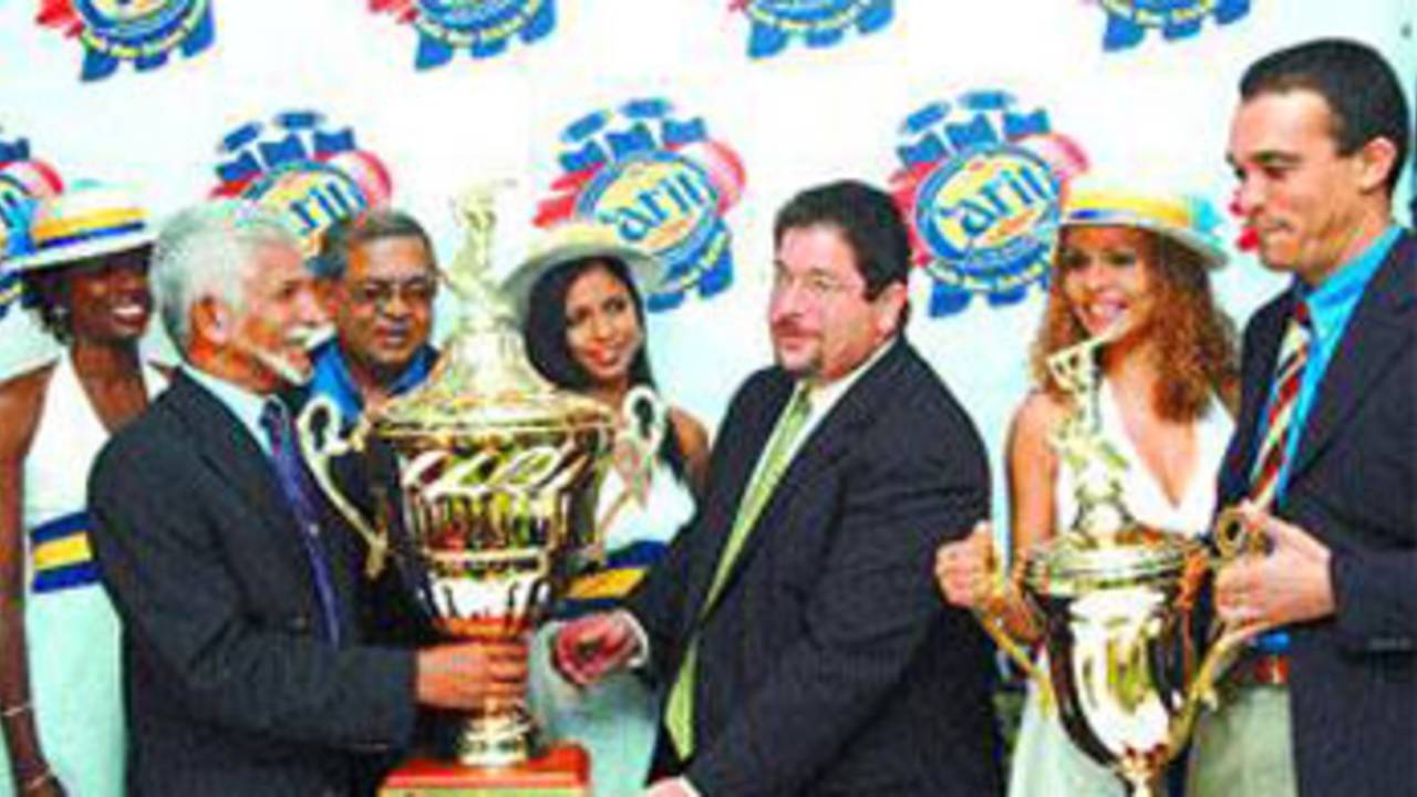 Deryck Murray receives the Carib International Challenge Trophy from Carib CEO Andrew Sabga 