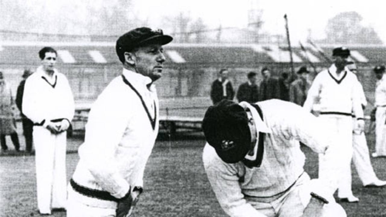 Don Bradman, 'box' in position, prepares to tune up in the nets at Lord's, 1948. Behind him, waiting to bowl, are Ernie Toshack (left) and Doug Ring, Lord's, May 1948