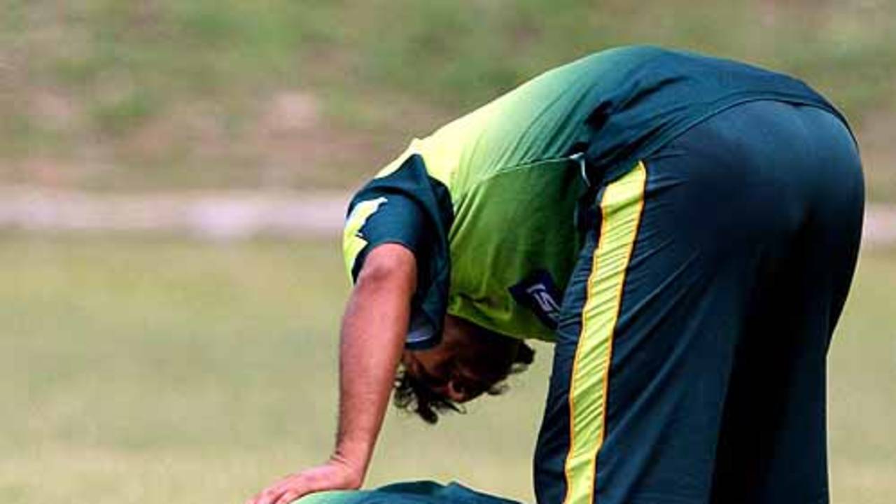 Mushtaq Ahmed writhes in pain with a broken nose during a practice session in Kingston, Jamaica, March 15, 2007 