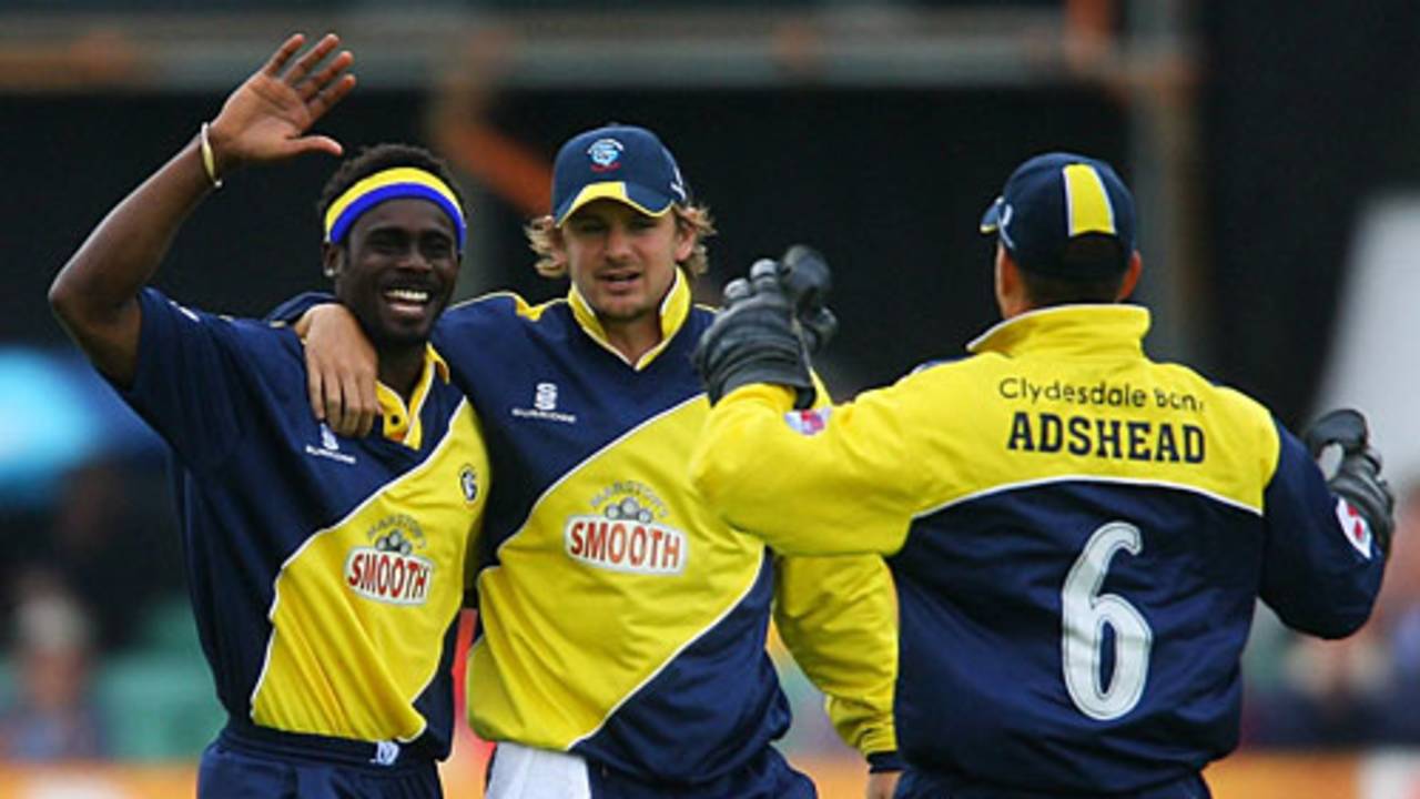 Carl Greenidge is congratulated after dismissing Phil Jaques