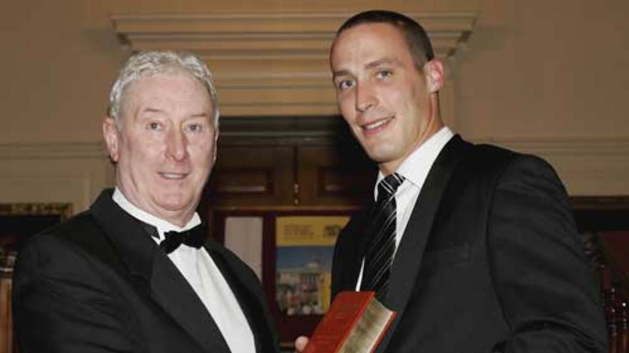 Simon Jones (R) is presented with his Wisden Cricketer of the year award by his father, former England Cricketer Jeff Jones, during the Wisden 2006 launch at the The Inner Temple Hall on April 11, 2006 in London, England.