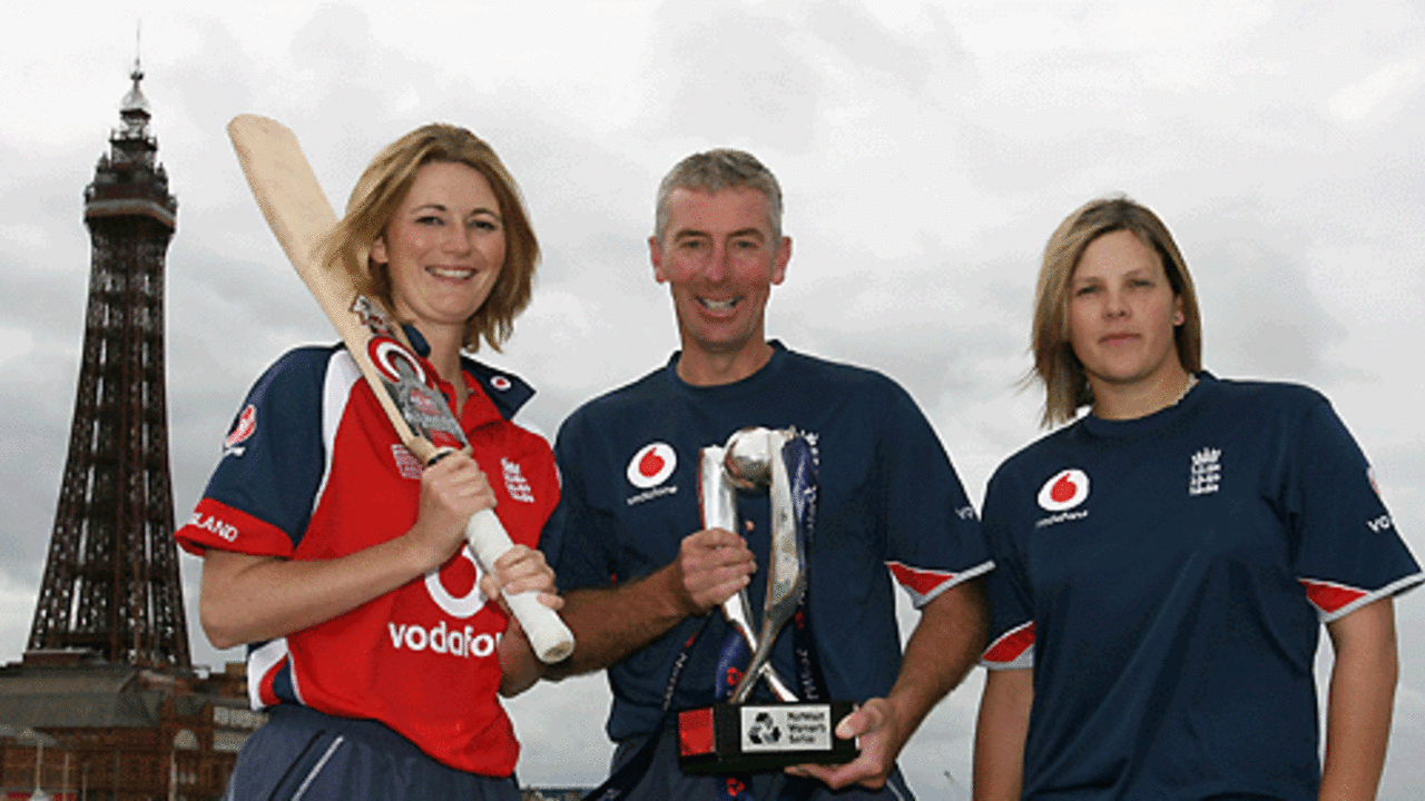 Charlotte Edwards, Mark Dobson, and Nicky Shaw with the NatWest Womens Series trophy in front of the Blackpool Tower