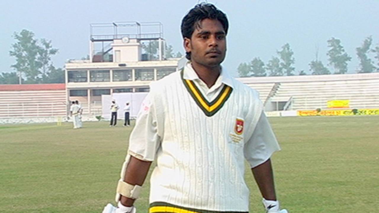 Golam Rahman returns to the pavilion after being dismissed for 45 