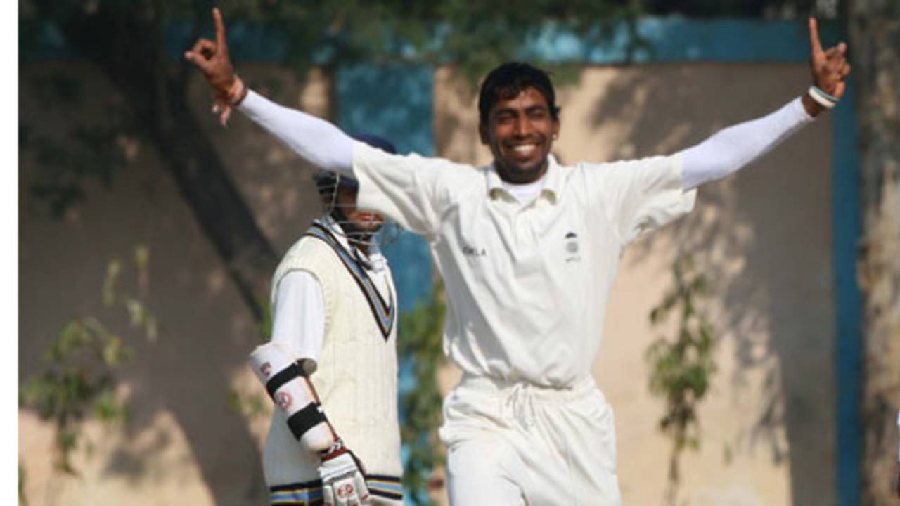 Madhya Pradesh's Sunil Dholpure is ecstatic after taking a wicket