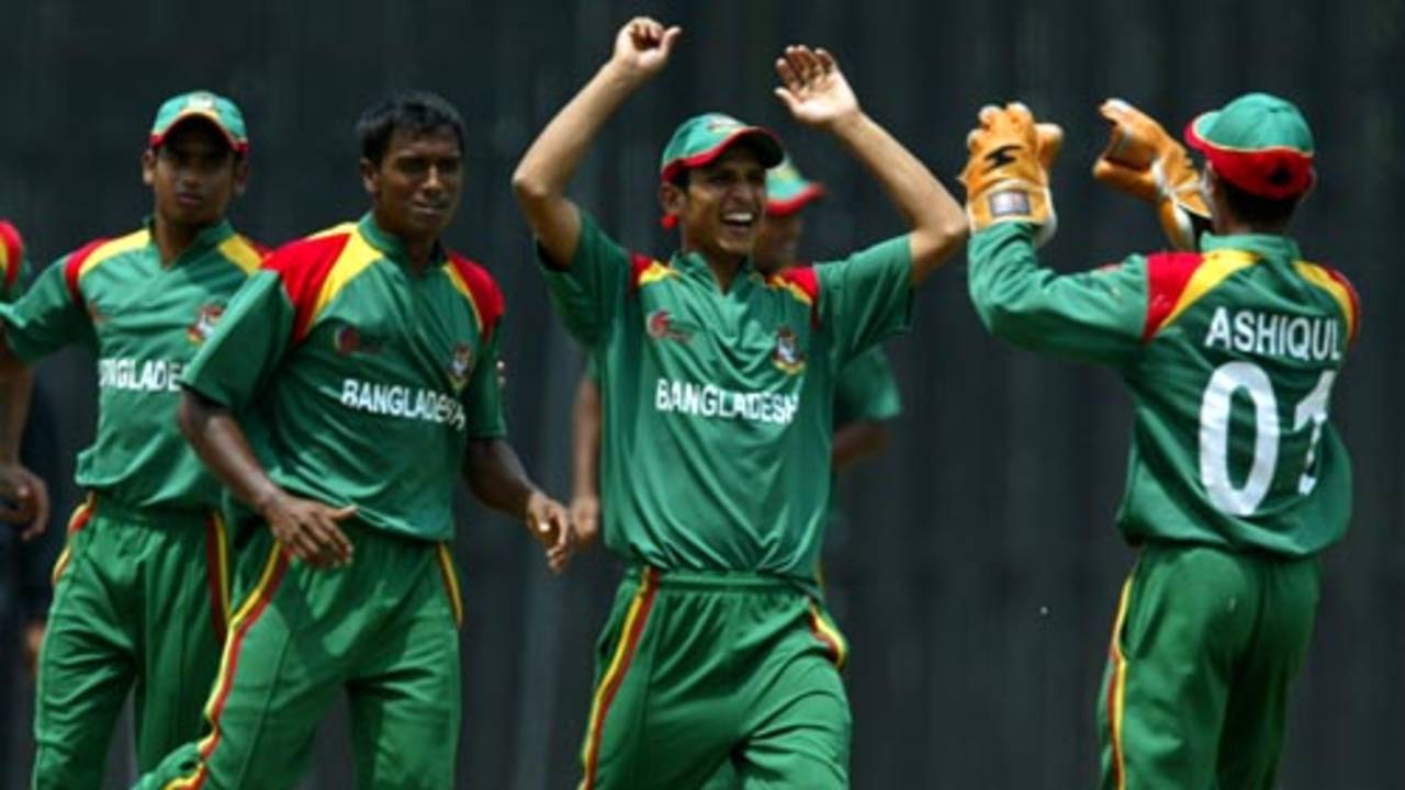 The Bangladesh players rejoice at the fall of a wicket