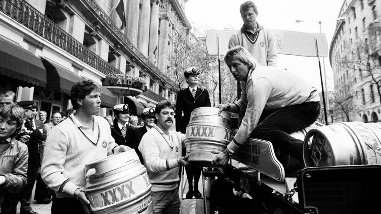 Greg Ritchie, David Boon, Jeff Thomson and Craig McDermott (back) help to load the first shipment of barrels of Australian lager Castlemaine XXXX onto a horse-drawn dray, London, May 15, 1985