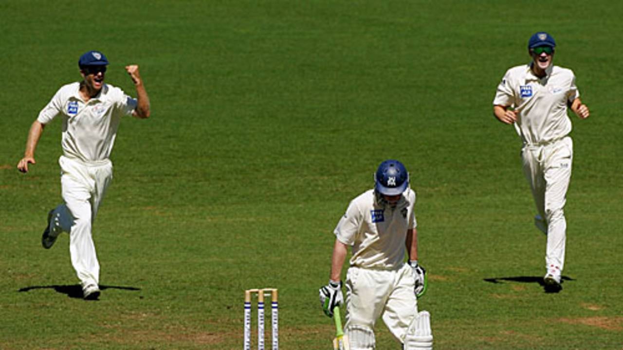 Simon Katich and Michael Clarke rush in after Lloyd Mash's wicket