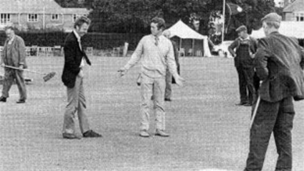 Richard Gilliatt gives a rueful smile as John Hampshire explains the state of the pitch as rain washed out the match, therefore robbing Hampshire (the county) of a chance of retaining their Championship crown, Bournemouth September 3, 1974