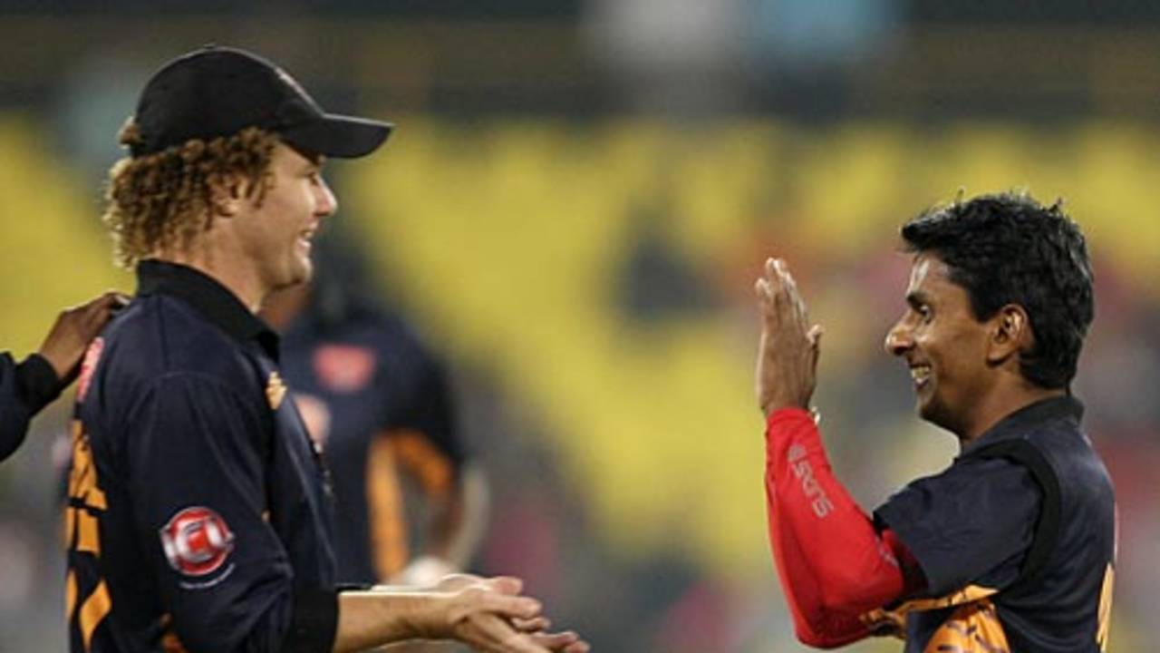 Hamish Marshall and Upul Chandana celebrate the fall of a wicket