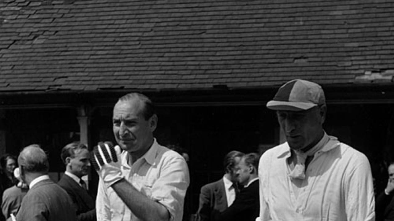 Douglas Jardine (right) walks in to bat in a charity match, 1951