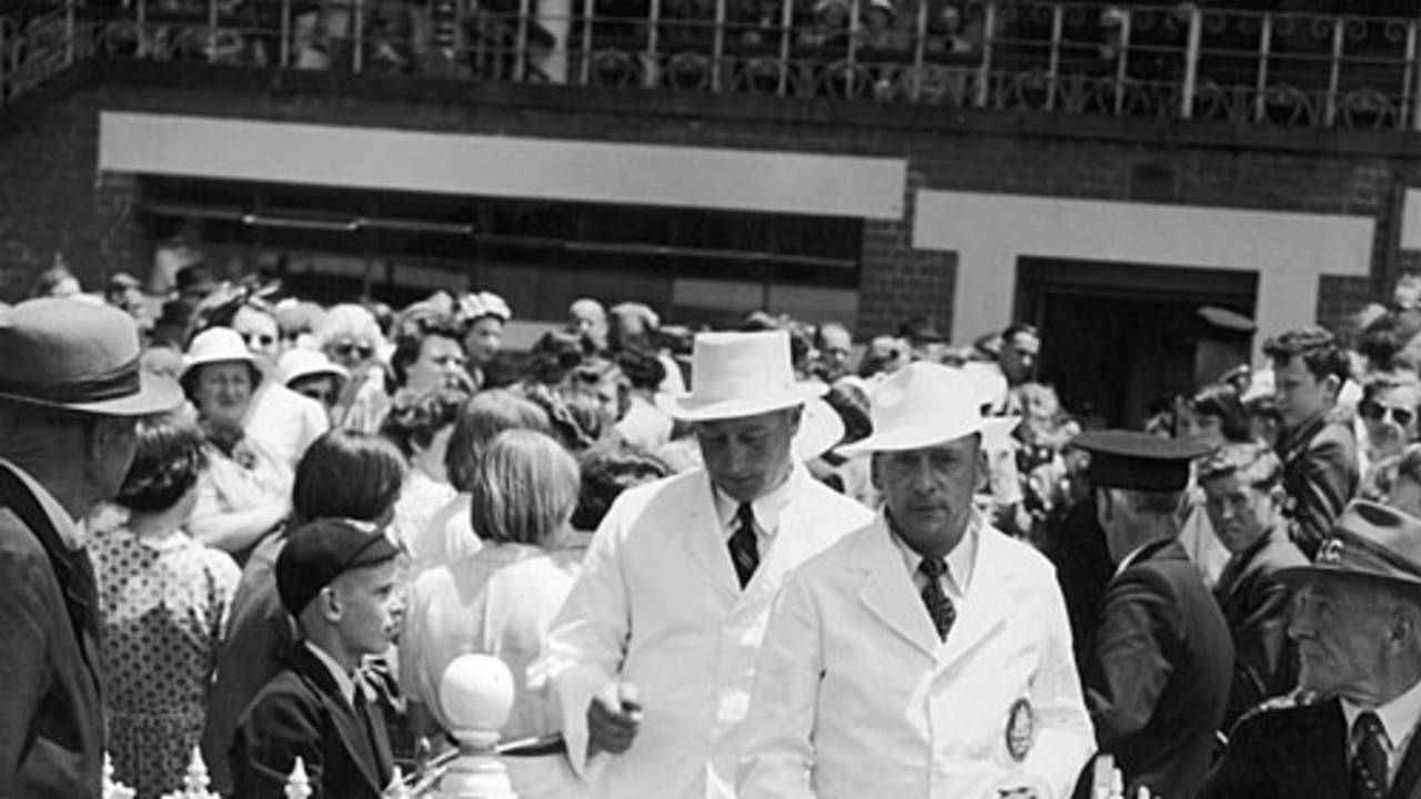 Umpires Ronald Wright and George Cooper walk on to the field on Boxing Day, Australia v England, MCG, 3rd day, December 26, 1950