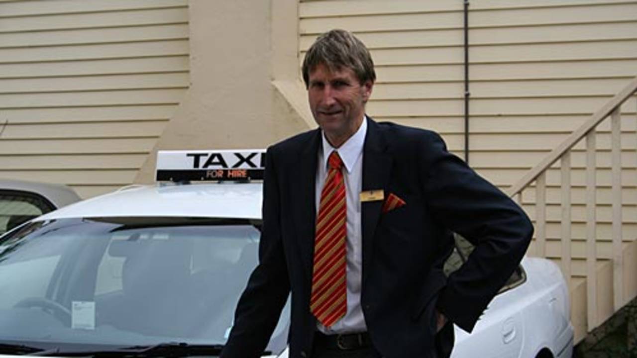 Ewen Chatfield poses beside his taxi