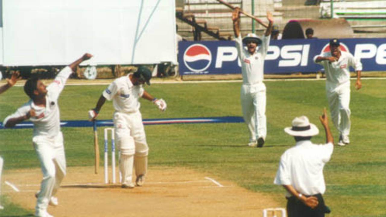 Saeed Anwar is out lbw, shouldering arms. Srinath exults as Ganguly and Laxman in the slips rush forward. India v Pakistan, Test 1, Day 1 at Chennai, 28 January 1999