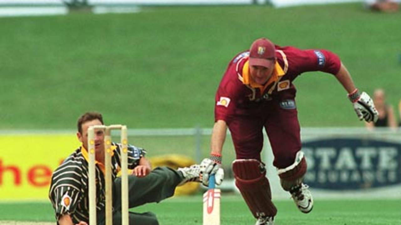 Northern Districts batsman Grant Bradburn is forced to dive back into his crease after being sent back by his batting partner as Central Districts bowler Andrew Schwass fields off his own bowling. Schwass elected not to throw at the stumps. Shell Cup Semi Final: Central Districts v Northern Districts at McLean Park, Napier, 21 January 2001