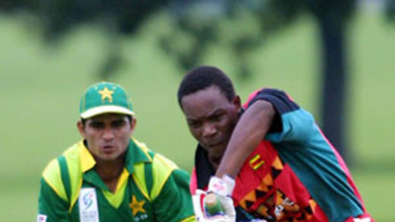 Zimbabwe Under-19 batsman Hamilton Masakadza plays a defensive shot as Pakistan Under-19 wicket-keeper Amin-ur-Rehman looks on. ICC Under-19 World Cup Warmup: Pakistan Under-19 v Zimbabwe Under-19 at Hagley Oval, Christchurch, 16 January 2002.