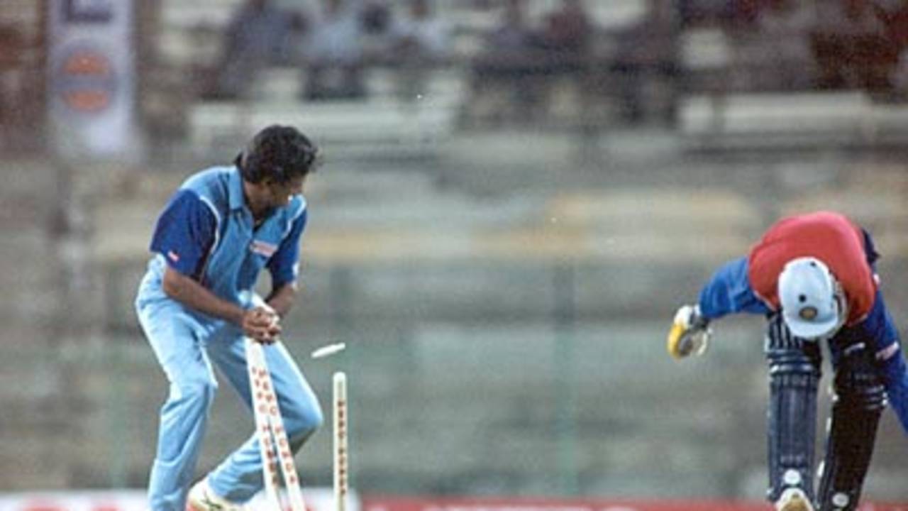 Chopra is caught short of his crease as Srinath breaks the stumps