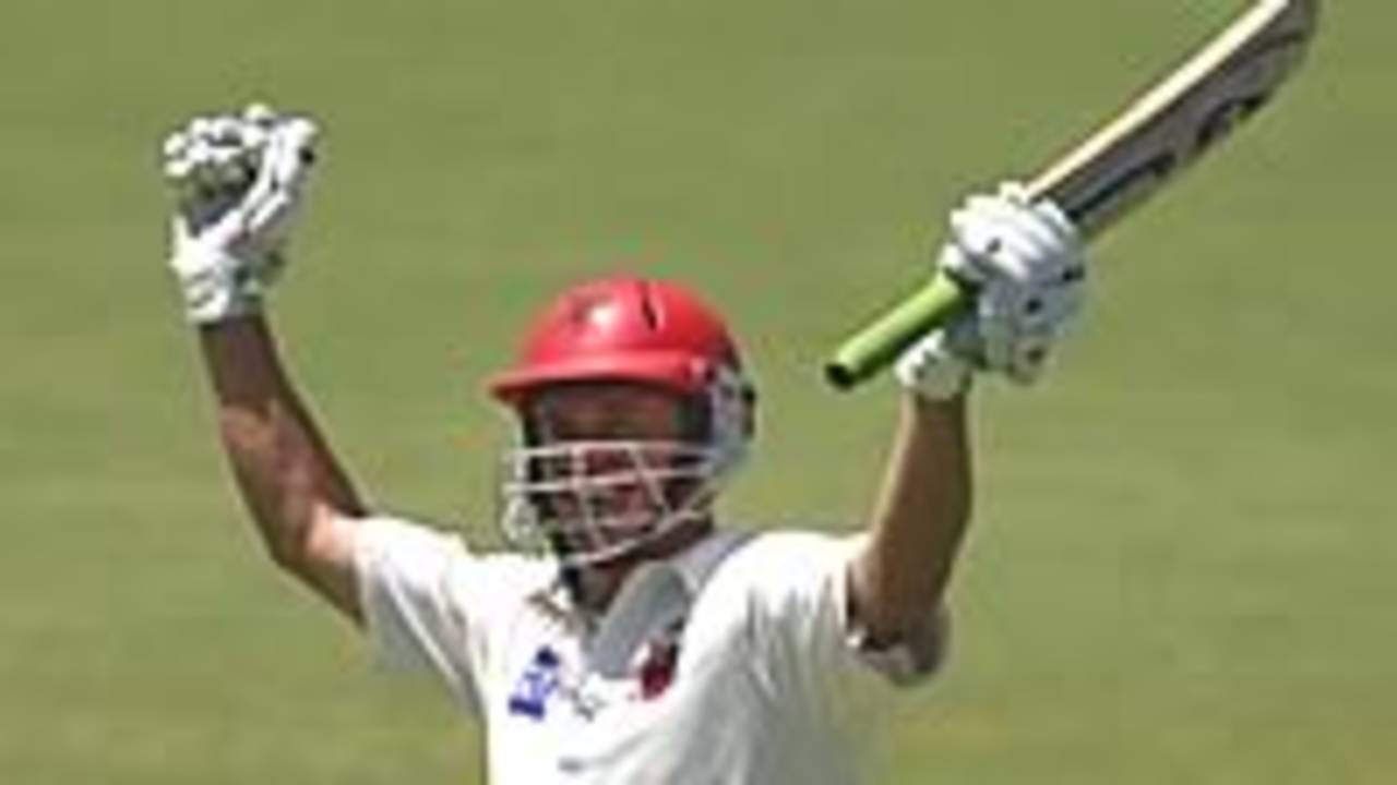 ADELAIDE - FEBRUARY 5: Brad Young celebrates his century during the Pura Cup match between the Southern Redbacks and the Queensland Bulls at Adelaide Oval in Adelaide, Australia on February 5, 2003. He made a record-breaking eighth-wicket partnership of 222 with Michael Miller.