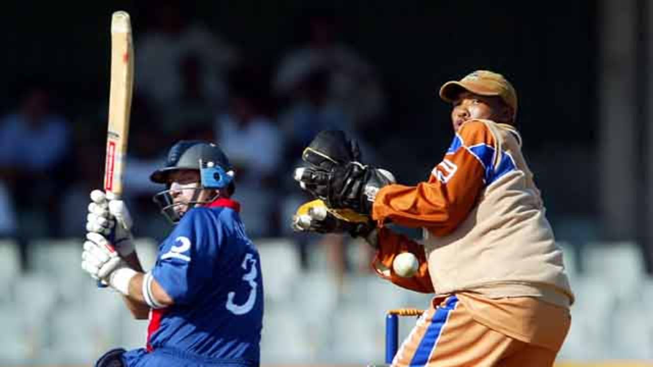 England's skipper Nasser Hussain sweeps behind as Border Bears' wicket keeper Abongile Sodumo