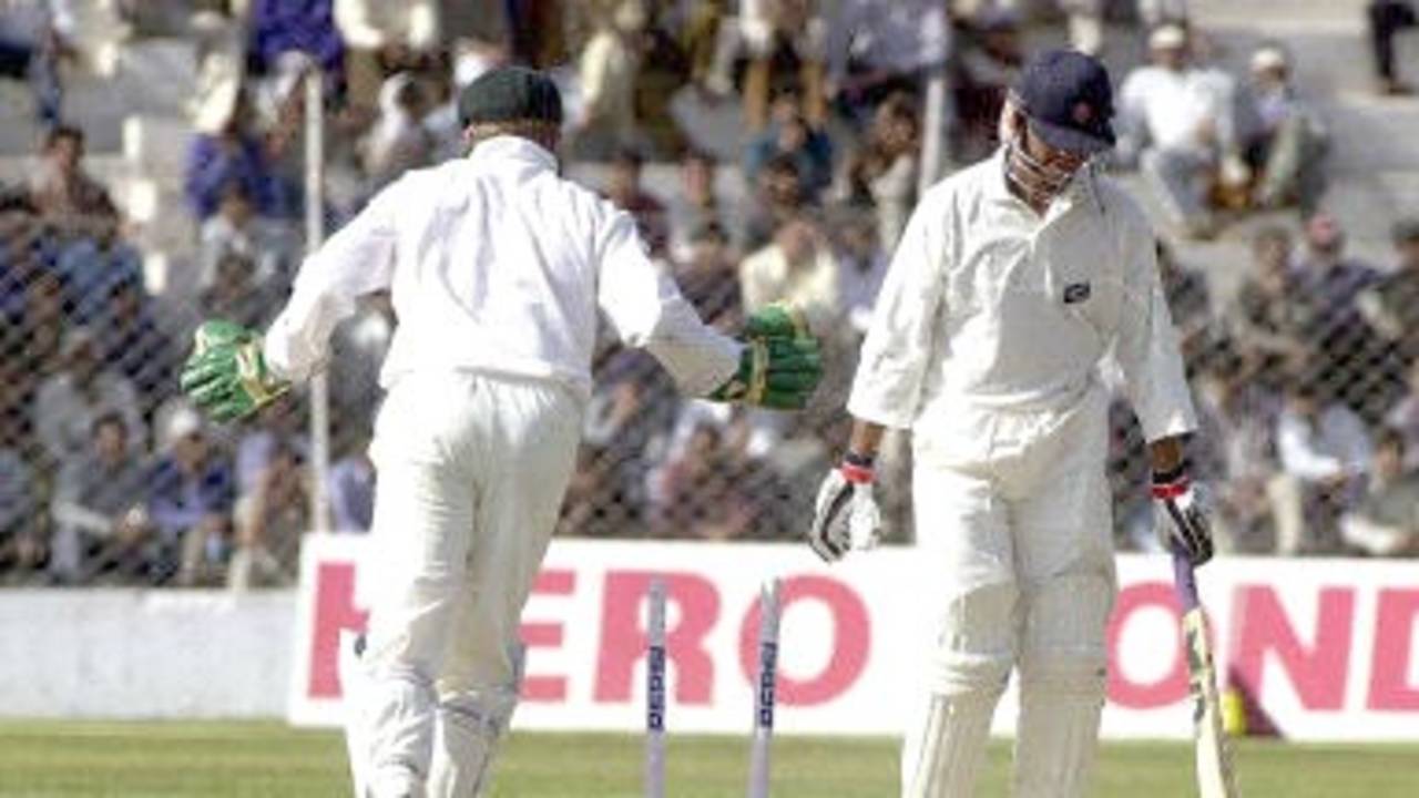 Board President's XI batsman Rakesh Patel (R) is bowled by Australian bowler Colin Miller as wicketkeeper Brad Haddin (L) looks on during the second day of their three-day match in New Delhi 07 March 2001. Australia scored 451 in their first innings with India 221 all out.