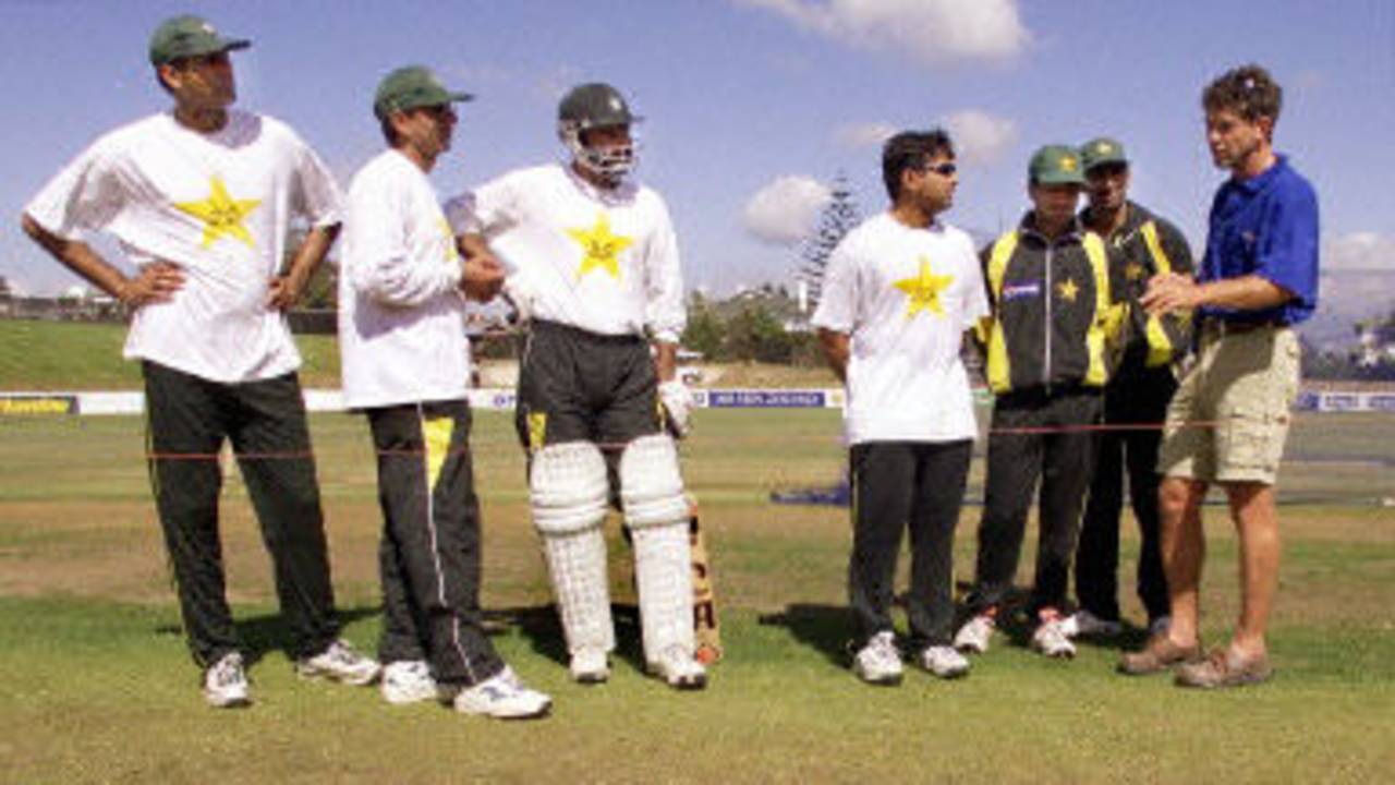 Pakistan cricketers listen to groundsman Doug Strachen