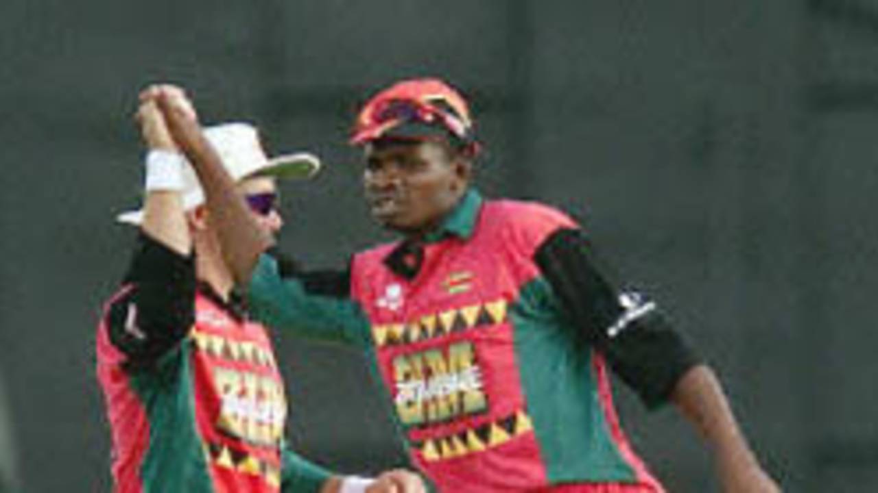 Heath Streak and David Mutendera link hands after Zimbabwe's 127 run win