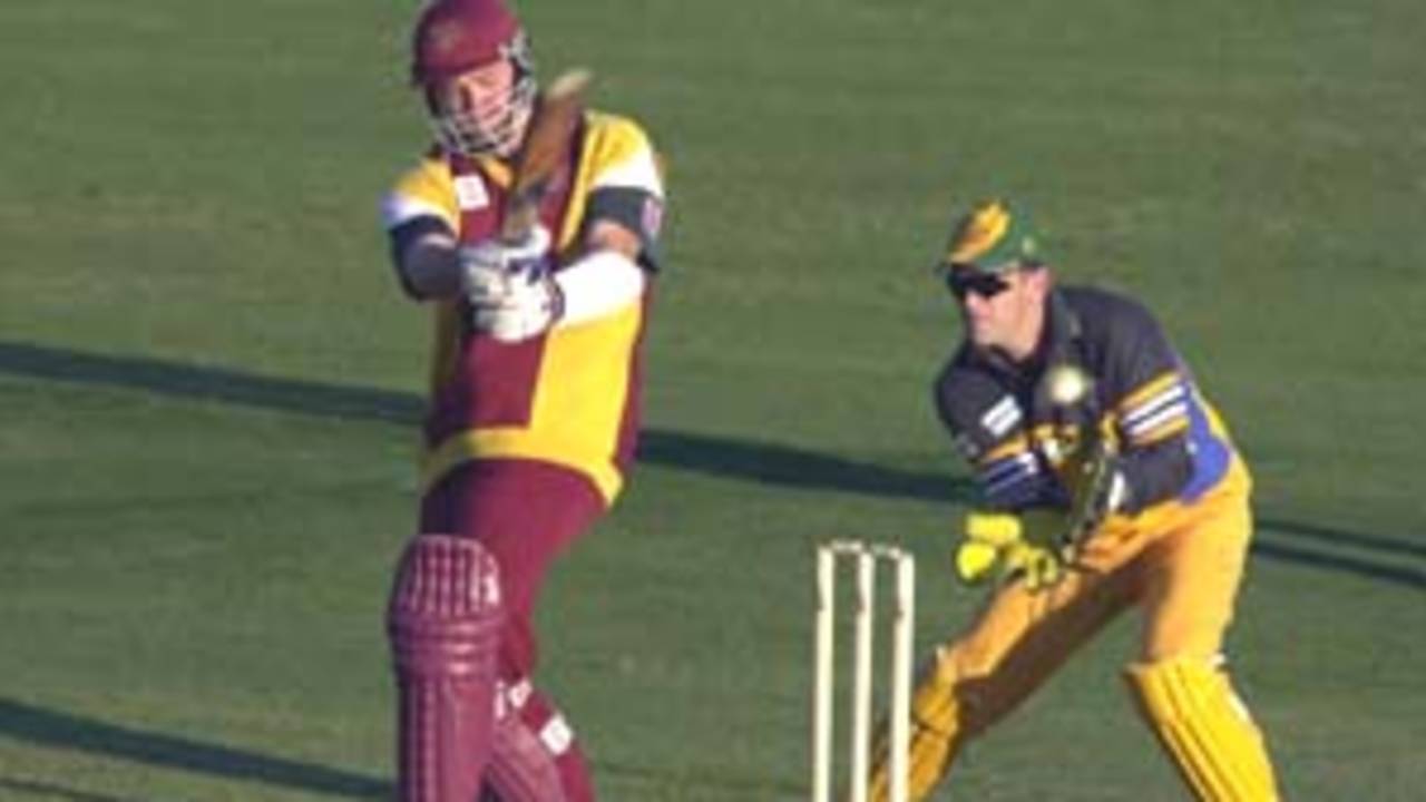 11 Aug 2000: Scott Muller of Queensland in action while Adam Gilchrist of Australia looks on during the Australia versus Queensland practice match played at Allan Border Field in Brisbane, Australia. The Australian team are playing the practice match to prepare for the Super Challenge 2000 against South Africa.