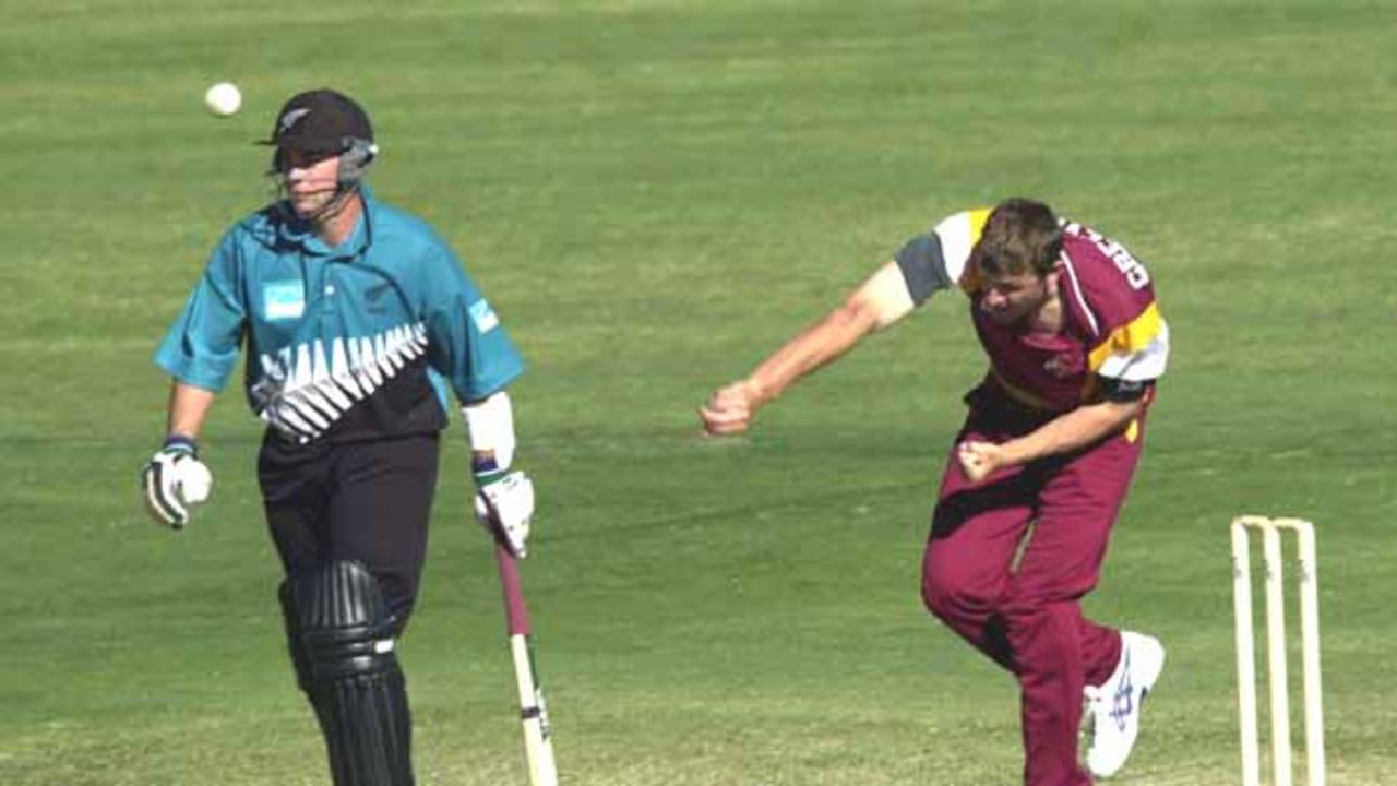 15 Aug 2000: Brendan Creevey of Queensland in action bowling while Craig McMillan of New Zealand looks on during the New Zealand versus Queensland practice match at Allan Border Field in Brisbane, Australia. Queensland won the game by 23 runs.