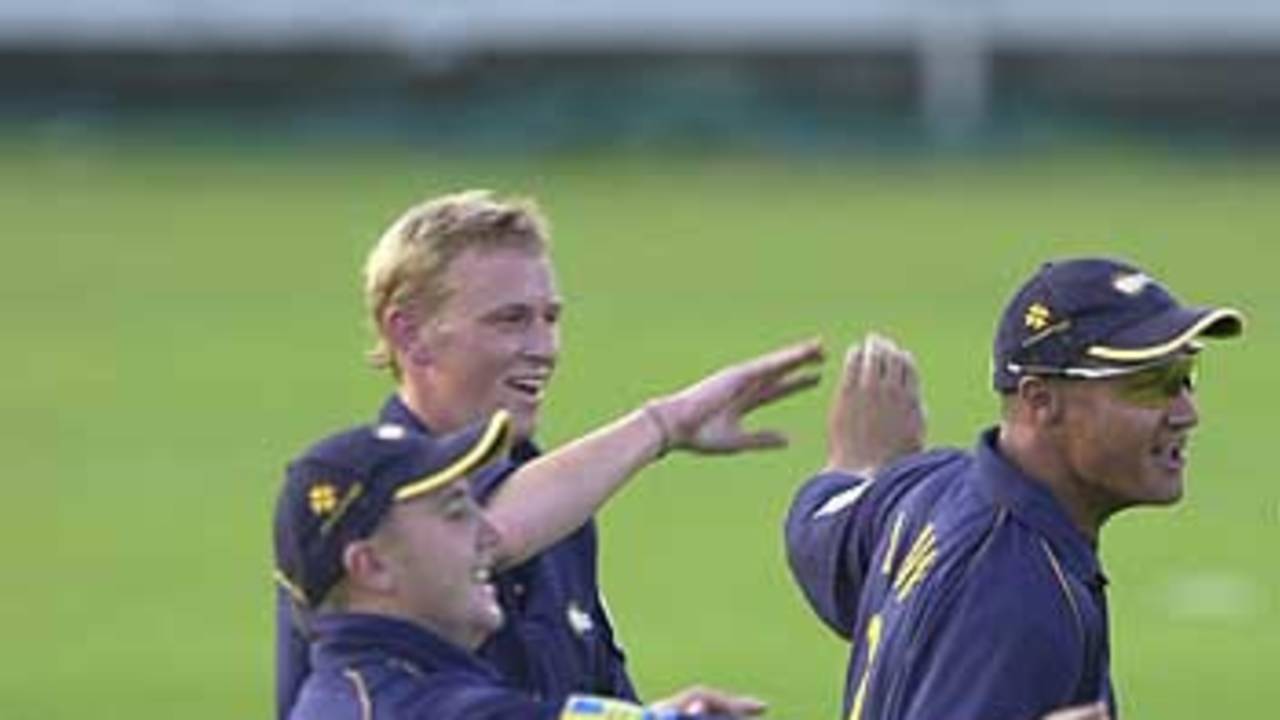 From the left, Ashley Thorpe, bowler Mark Davies and Danny Law celebrate the dismissal of Ian Thomas
