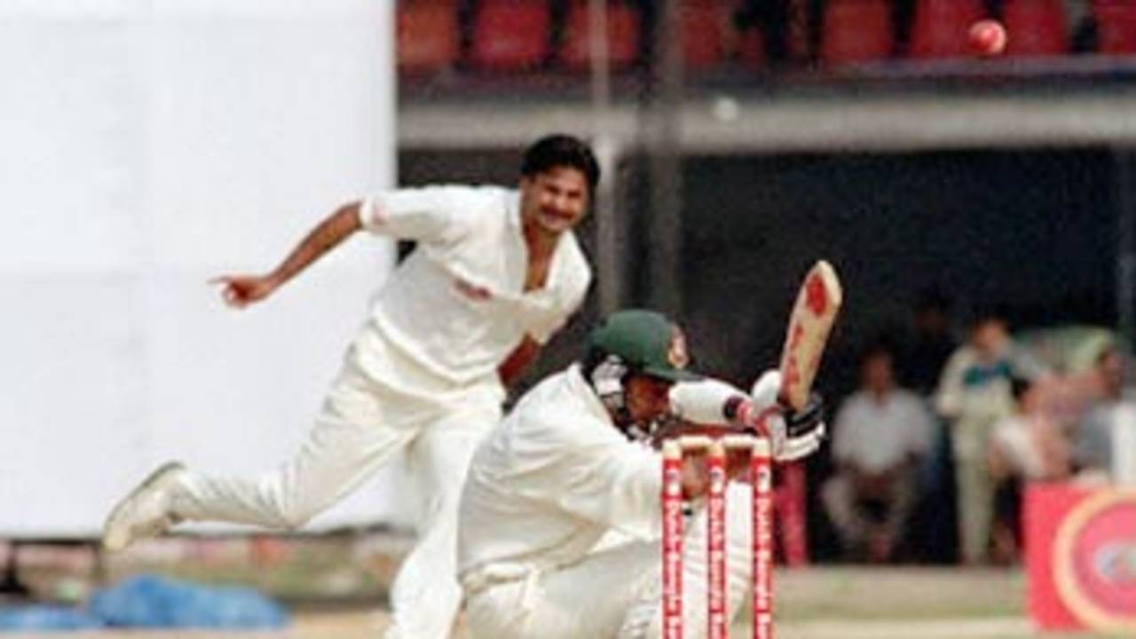 Bangladeshi bastman Shahriar Hossain crouches from a ball off Indian pacer Javagal Srinath 10 November 2000 at the Bangabandhu National Stadium during this South Asian country's inaugural Test match against India. Shariar who scored 12, before being caught by the Indian skipper Sourav Ganguly off Sunil Joshi.