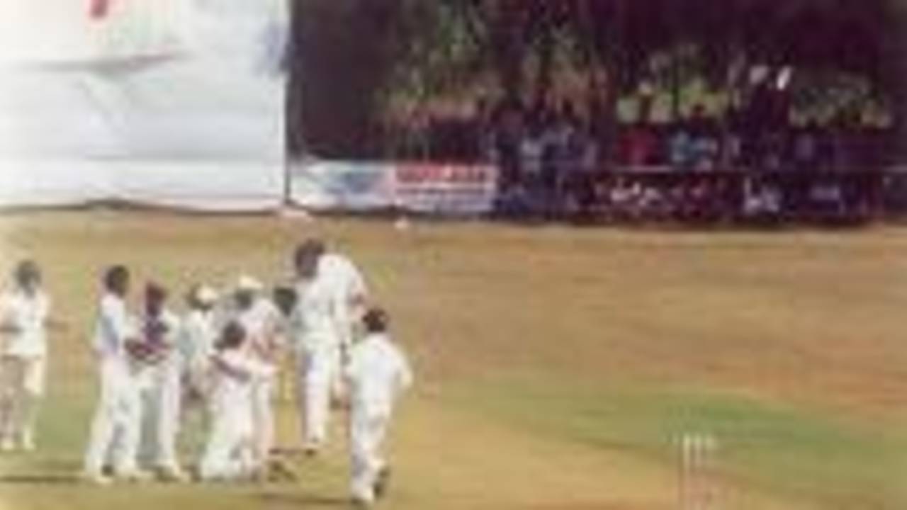 Shahbuddin being congratulated by team members after Ganesh got out, Ranji Trophy South Zone League, 2000/01, Karnataka v Andhra, Union Gymkhana Ground, Belgaum, 15-18 November 2000 (Day 2).