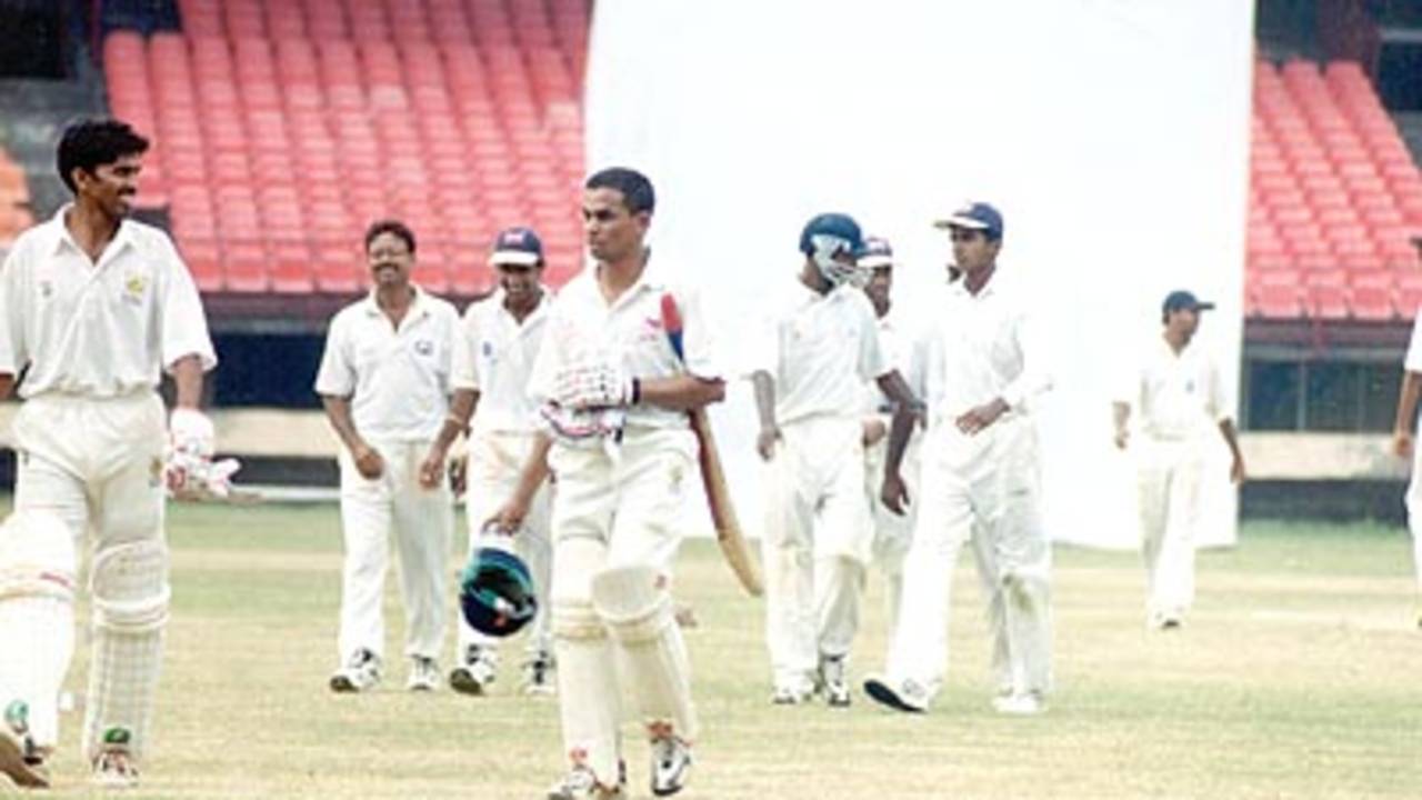 ND Kambli and RP Rane leave the field along with Kerala players after the match ended