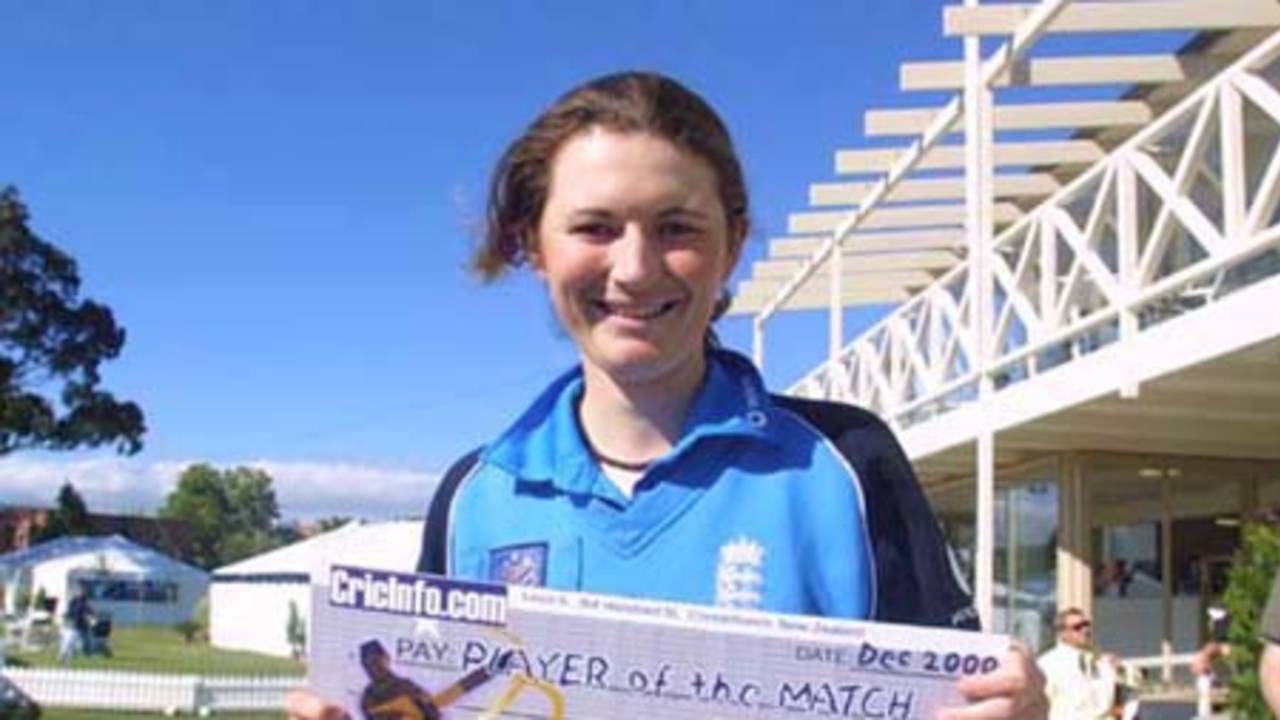 England 's keeper Charlotte Edwards with the match award winners cheque