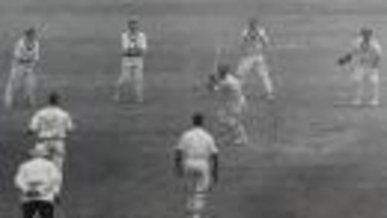Bill Edrich plays on to Ron Archer in the second Test at Sydney, with Lindwall, Davidson and Hole lined up alongside wicketkeeper Langley, and Evans non-striker, 1954-55