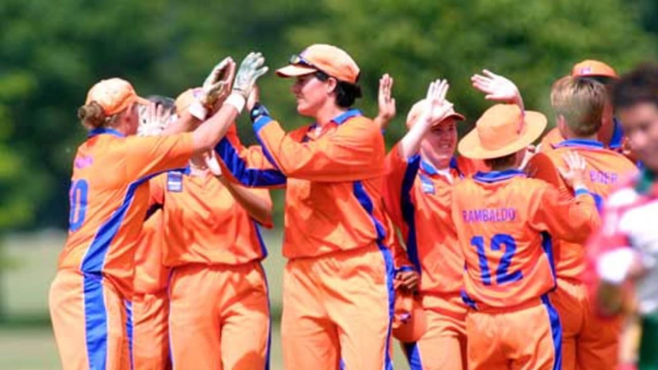 Netherlands players celebrate the wicket of O'Neill