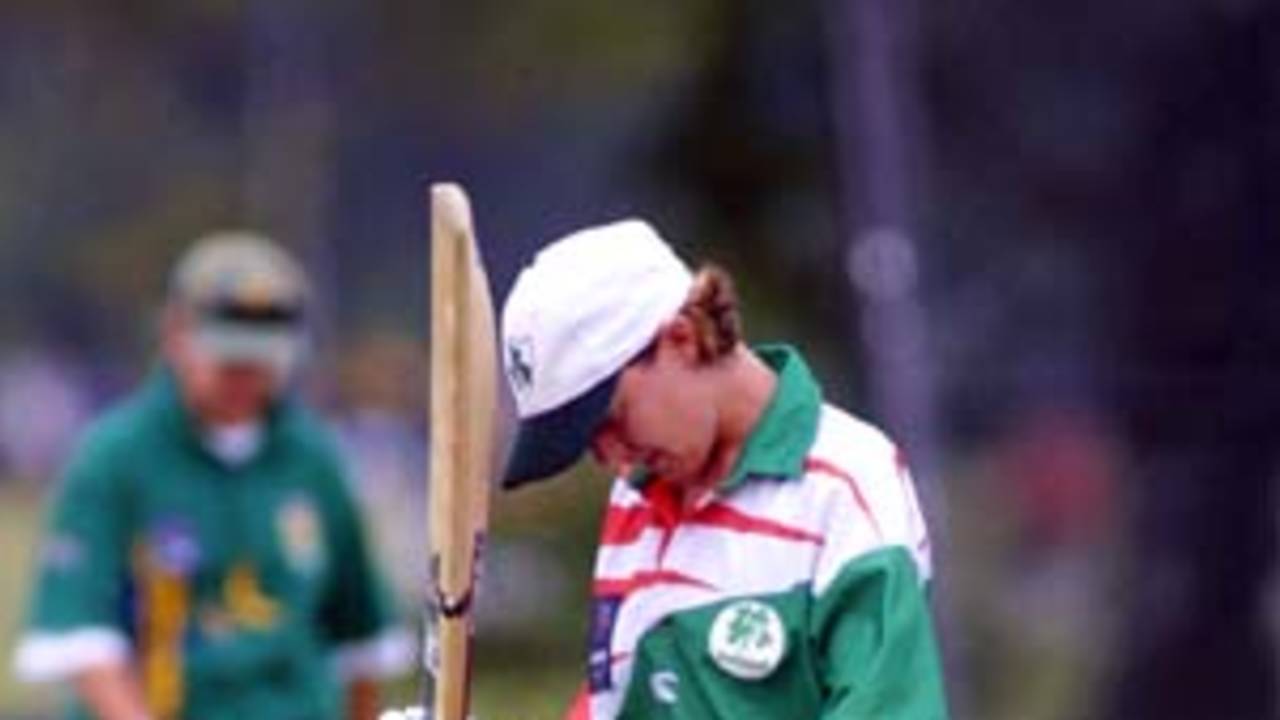 Anna Linehan hangs her head and with disappointment knocks the bat against it after being caught by Anina Burger for 40