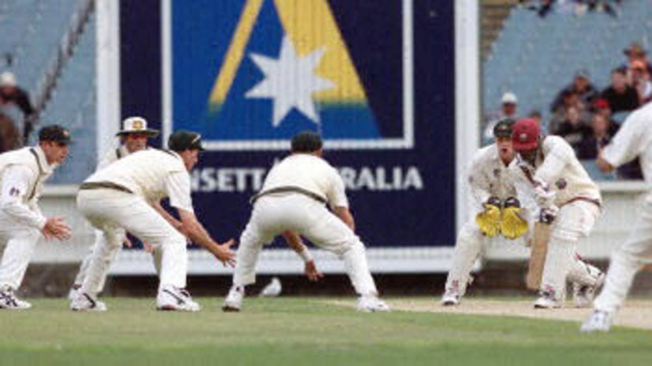 West Indian batsman Colin Stuart (2/R) is surrounded by close-in Australian fielders after the West Indies lost three quick wickets late on the third day of the fourth Test Match at the MCG in Melbourne, 28 December 2000. Australia declared their second innings close at 262-5 and at stumps the West Indies are again in deep trouble at 10-3 chasing 462 to win.