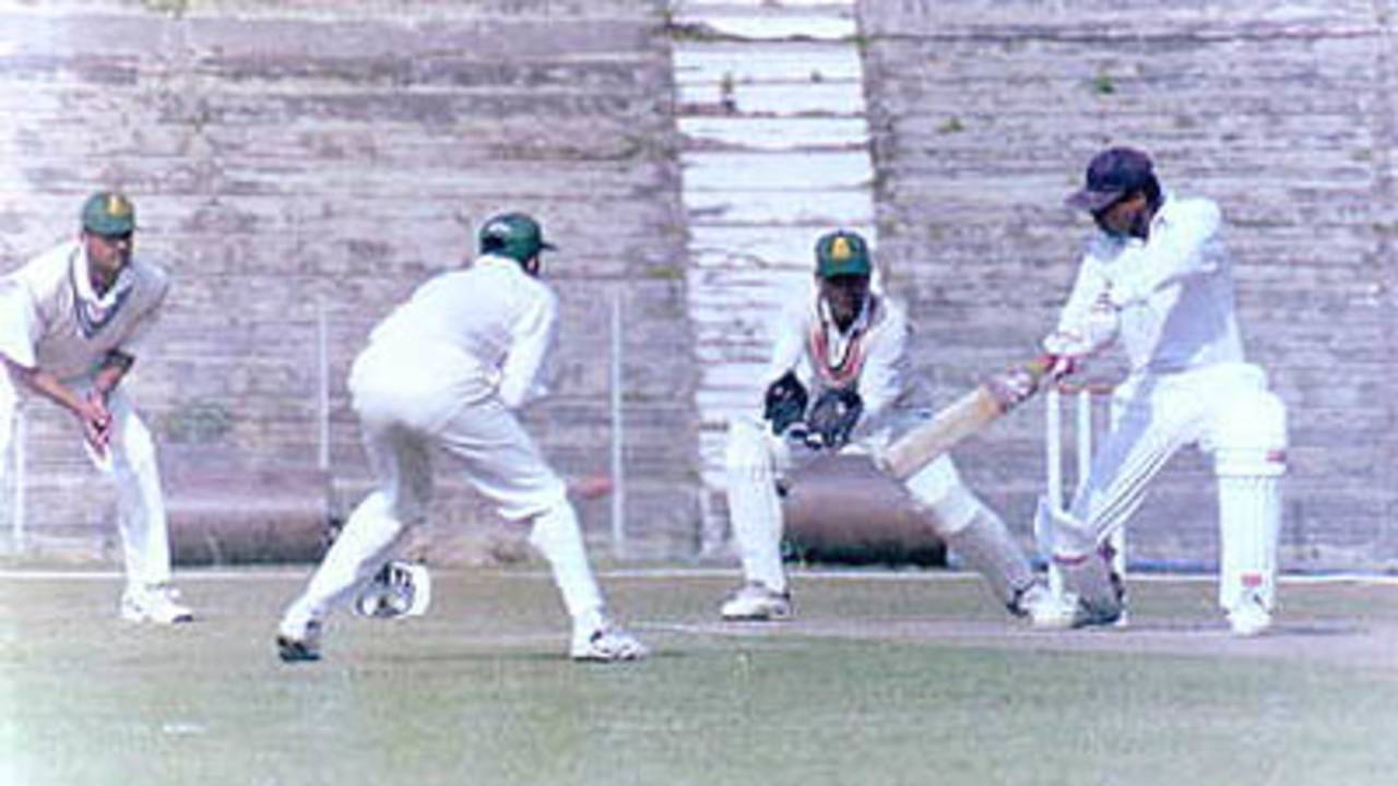S Bose of Tripura cuts the ball. Ranji Trophy East Zone League, 2000/01, Tripura v Assam, Maharaja Bir Bikram College Stadium, Agartala, 14-16 December 2000.